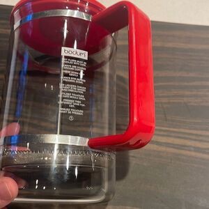 Bodum French press glass crafe  red plastic handle and lid makes great coffee.